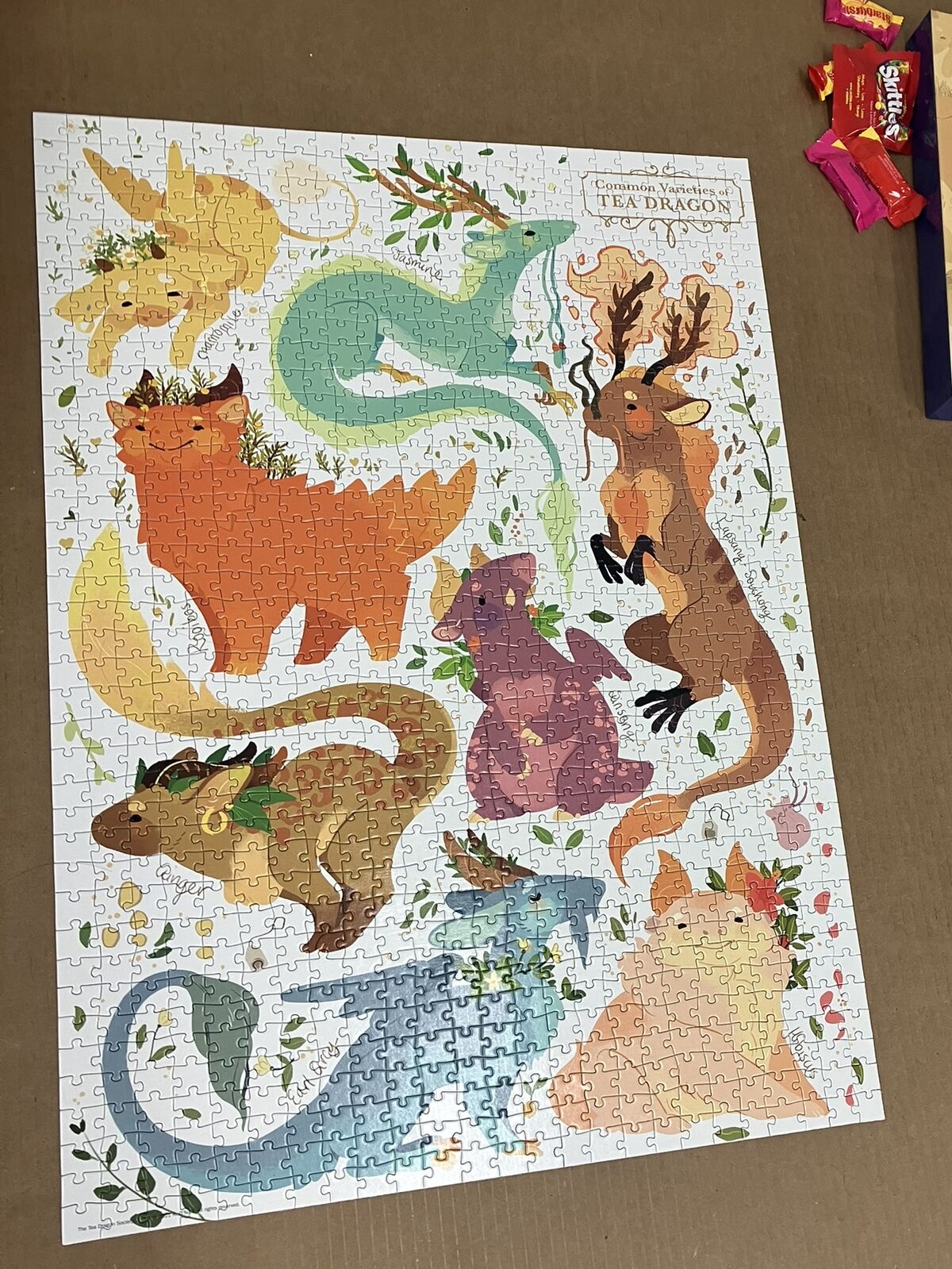 A completed 1000 piece puzzle of eight cartoon dragons themed after different teas.
